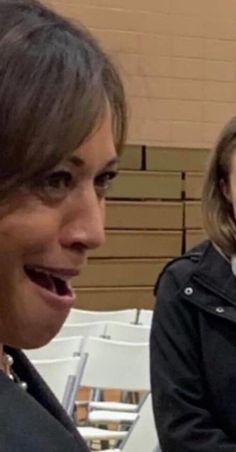 two women sitting next to each other at a table