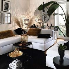 a living room filled with lots of white furniture