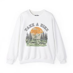 Embrace the beauty of nature with our "Take a Hike Sunrise" Women's Sweatshirt. Perfect for outdoor enthusiasts and nature lovers alike, this cozy sweatshirt features a stunning sunrise graphic that evokes feelings of adventure and tranquility. Made from soft and comfortable fabric, it's ideal for layering on chilly mornings or evenings around the campfire. Whether you're hitting the trails or simply enjoying a leisurely stroll in the woods, this sweatshirt is sure to keep you warm and stylish. Trendy Outdoor Sweatshirt With Graphic Print, Casual Graphic Print Sweatshirt For Hiking, Cotton Graphic Print Sweatshirt For Adventure, Outdoor Graphic Print Fleece Sweatshirt, Long Sleeve Graphic T-shirt For Hiking, Take A Hike, Beautiful Morning, Cozy Sweatshirts, Gifts For Nature Lovers