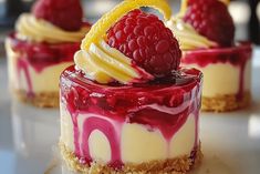 three desserts with raspberry sauce and lemon on top