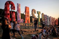 many people are sitting in front of large letters