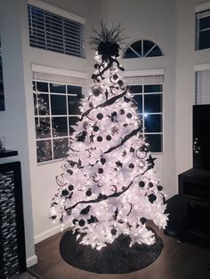 a white christmas tree with mickey mouse decorations