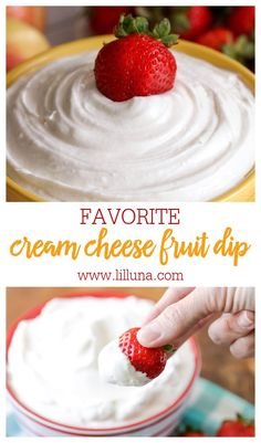 a bowl filled with cream cheese fruit dip and a hand holding a strawberry over it