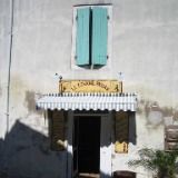 an old white building with green shutters