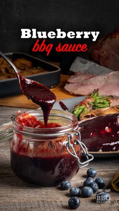 blueberry bbq sauce in a glass jar with a spoon sticking out of it