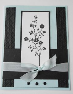 a close up of a card with a bow on the front and flowers on the back