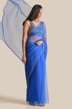 Royal blue saree with pita, resham and cutdana embroidered borders. Comes with a padded blouse.
Components: 2
Pattern: Embroidered
Type Of Work: Pita, Resham, Cutdana
Neckline: V Neck
Sleeve Type: Sleeveless
Fabric: Organza, Silk
Color: Blue
Other Details: 
Attached lining
Length: Blouse - 13 inches
Product Weight: 1 Kg
Occasion: Mehendi and Haldi - Aza Fashions Designer Blue Pre-draped Saree With Sheer Dupatta, Blue Tissue Silk Pre-draped Saree For Diwali, Festive Blue Cotton Silk Pre-draped Saree, Blue Cotton Silk Pre-draped Saree With Zari Work, Blue Cotton Silk Dupatta For Reception, Blue Chanderi Saree For Reception, Anarkali Saree With Sheer Dupatta, Bollywood Style Blue Cotton Silk Choli, Fitted Blue Chanderi Pre-draped Saree