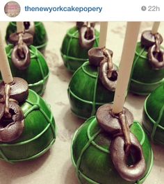 there are many small green cakes with candles in the shape of mushrooms on top of them