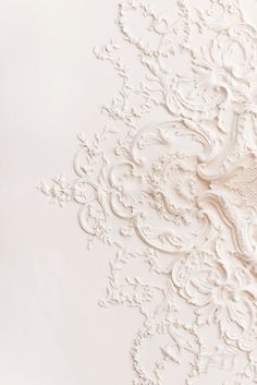 an intricately designed wallpaper with white paint