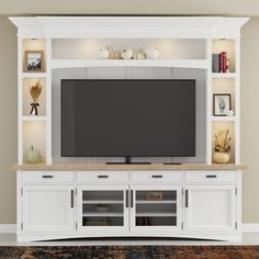 an entertainment center with a large flat screen tv mounted on it's side wall