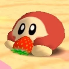 a red and white animal with a strawberry in it's mouth sitting on the ground