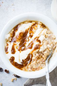 a bowl of oatmeal with raisins and yogurt