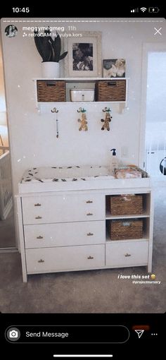 a baby crib with baskets on the top and shelves above it in a room