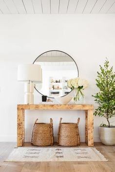 a table with two baskets and a mirror on it