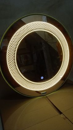 a round mirror sitting on top of a wooden table