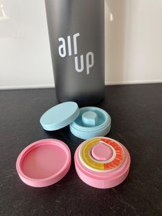 an air up lunch box and its contents on a black countertop next to a plastic container