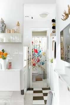 a kitchen with a checkered floor and white walls