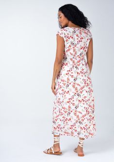 A beautiful bohemian midi dress in a rose pink floral print, with sexy side cutouts. Cotton blend Floral print Relaxed fit Short cap sleeves Mid-length V-neckline Half-elastic waist at the back Self-covered button front Side waist cutouts Women's bohemian spring dress Sexy side-waist cutouts elevate this classic mid-length dress. Designed in a cheerful floral print, with short cap sleeves, a self-covered button front, and a flattering v-neckline. Perfect for spring and summer, we love to pair it Feminine Rayon Midi Dress With V-neck, V-neck Beach Dress With Rose Print, Bohemian Midi Dress With Surplice Neckline And Floral Print, Beach Floral Print Midi Dress With Surplice Neckline, Beach Midi Dress With Surplice Neckline And Floral Print, Floral Midi Dress With Surplice Neckline For Beach, Pink V-neck Maxi Dress With Rose Print, Casual Fitted Maxi Dress With Rose Print, Casual V-neck Floral Print Maxi Dress