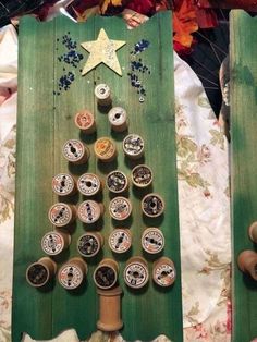 a christmas tree made out of bottle caps is displayed in front of some other items