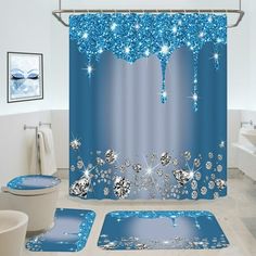 a bathroom with blue shower curtains and rugs in the shape of snowflakes