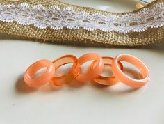 These clear and opaque pumpkin coloured rings are perfect for stacking but can easily be a stand alone ring - simple and bold at the same time!  These stackable rings can be ordered in clear or opaque - or wear them together to create your own aesthetic.  These resin bands have a minimalist feel while still being an eye catching statement piece - it's the best of both worlds! Our pumpkin rings come in two shapes, either flat edge, or rounded, but not all sizes come in both so please choose your size and ring shape from the drop box :).  Your ring will be made specially for you so please allow up to a week from the time your ring is ordered, to dispatch your package - resin needs to cure for 48 to 72 hours :).  Resin Jewellery is extremely light weight and easy to wear!  All of our pieces a Orange Rings, Pumpkin Ring, Orange Ceramic, Orange Ring, Resin Rings, Ceramic Ring, Pumpkin Colors, Ring Shapes, Resin Ring