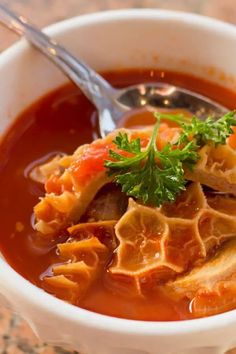 a white bowl filled with soup on top of a table