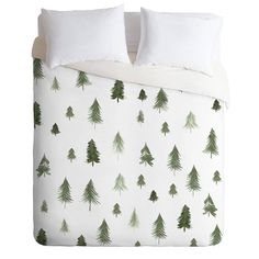 a white bed with green trees on it