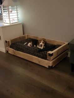 a dog is laying in his bed on the floor