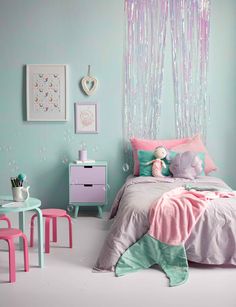 a bedroom decorated in pastel colors with pink and green accents