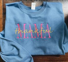 Color cordinate your own "Mama blessed or thankful or MAMA only  " embroidered sweatshirt ,   *As shown in images font style will remain same!  *Image Sweatshirt :This is embroidered design onto denim color sweatshirt. *I have several Thread color choices available you can choose from in personalization option! (white,black,cream/tan,brown,orange,bright green, hot pink,golden yellow, blue, red, gray). -Material is 50%cotton and 50%polyester. -This is unisex fitting sweatshirt:Size chart is liste Custom Text Sweatshirt With Relaxed Fit For Fall, Blue Letter Embroidery Sweatshirt For Fall, Blue Sweatshirt With Letter Embroidery For Fall, Blue Embroidered Sweatshirt For Fall, Casual Sweatshirt With Custom Embroidery For Mother's Day, Long Sleeve Sweatshirt With Embroidered Text For Mother's Day, Mother's Day Long Sleeve Sweatshirt With Embroidered Text, Casual Fall Sweatshirt With Custom Text, Casual Fall Tops With Custom Text