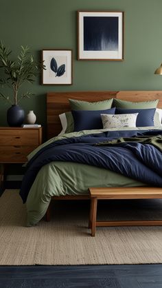 a bedroom with green walls and blue bedding in the center, along with two nightstands on either side