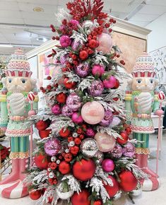 a christmas tree decorated with red and pink ornaments