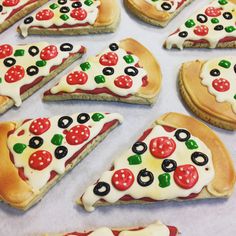 several slices of pizza with different toppings are arranged on a baking sheet and ready to be eaten