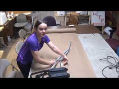 a woman holding a knife on top of a table