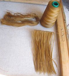 two spools of thread sitting on top of a table