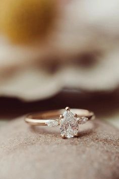 a diamond ring sitting on top of a rock