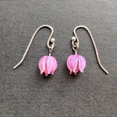 These little blossom earrings are made from translucent pink glass and are durable and lightweight.  These would be a great pair of earrings for someone who needs extremely lightweight earrings or for somebody's first pair of dangling earrings.   Celebrate spring!  The ear wires are solid sterling silver which is safe for most people with metal allergies. Mini Earrings, Pink Blossom, Lightweight Earrings, Little Flowers, Dangling Earrings, Light Weight Earrings, Bubblegum Pink, Pink Glass, Cute Earrings