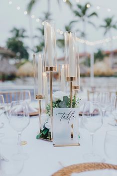 a table is set up with candles and place cards for guests to write their names