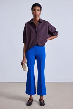 70% Viscose, 30% GRS Recycled Nylon Made in China Elastic waistband, center front and back seam detail, kick flare Dry clean only Inseam: 26 3/4” Size S front rise: 10 1/2" Runs large, we suggest sizing down Model is 5'10 and wearing a size small Blue Flare Pants In Elastane, Blue Flare Pants With Elastane, Blue Flare Pants For Work, Modern Blue Bottoms For Fall, Modern Wide Leg Blue Bottoms, Modern Blue Wide Leg Pants, Modern Wide Leg Blue Pants, Fitted Mid-rise Blue Wide Leg Pants, Chic Blue Flare Wide Leg Pants