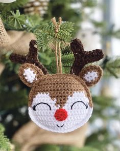 a crocheted reindeer ornament hanging from a tree with the caption rudolph ornaments free crochet pattern