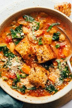 a bowl of soup with tofu and spinach