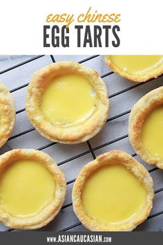 several small pies sitting on top of a cooling rack with yellow sauce in them