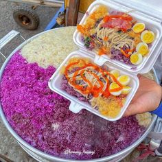 two plastic containers filled with food on top of a table