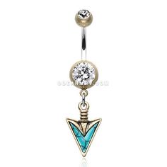 a gold and blue belly ring with an arrow on the end, surrounded by a crystal ball