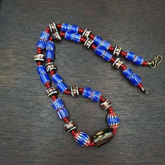 Vintage white heart Venetian Style Blue Chevron Glass Beads necklace N9-12 White Heart and Chevron Beads SIX Layer Type of Object Drawn, multi-layered glass Color BLUE, RED, White  Approximate Age Late 20th century Overall  * Condition: Good to fair.  * See picture with Size measurement tool for size comparison.  * Strand Length 22 inches (includes Lock) * Brand: East Oasis * Style: Beaded  * Type: Strand of beads Additional information: Chevron beads are the most beautiful, recogniz Traditional Heart Beads For Jewelry Making, Traditional Czech Glass Necklace With Polished Beads, Traditional Necklace With Polished Czech Glass Beads, Traditional Heart Shaped Bead Jewelry, Traditional Jewelry With Heart-shaped Round Beads, Artisan Beaded Necklace With Heart And Round Beads, Blue Artisan Necklace With Large Beads, Artisan Glass Necklaces With Oval Beads, Traditional Glass Beaded Necklaces With Oval Beads