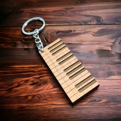 a wooden keychain with several rows of keys on it