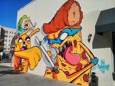 a large mural on the side of a building with cartoon characters painted all over it