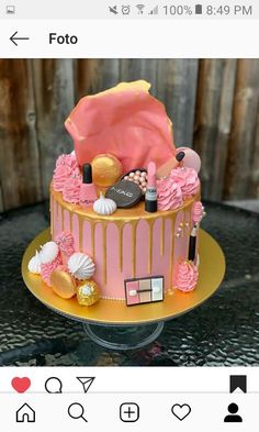 a pink and gold cake with makeup on top is shown in the instagramr