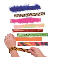 a person holding a pair of scissors in front of several different types of hair ties