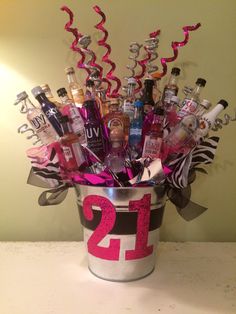 a bucket filled with lots of bottles and confetti on top of a table